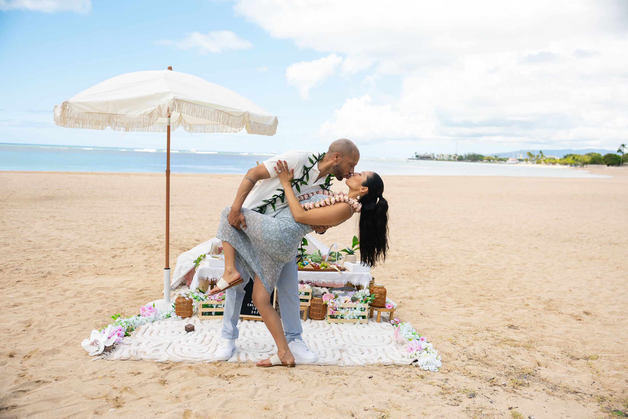 Couple celebrating at a styled beach picnic — Oahu Paradise Picnic